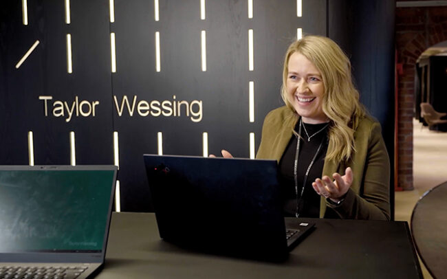 Taylor Wessing office woman on laptop